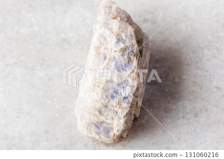 raw belomorite moonstone mineral on white marble 131060216