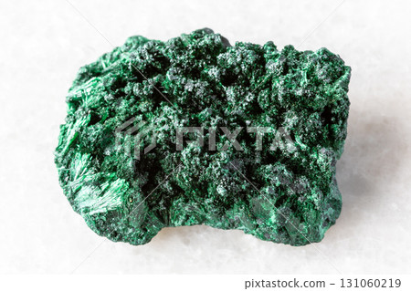 raw fibrous malachite mineral on white marble 131060219