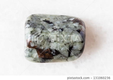 sample of tumbled khibinite ock on white marble sample of tumbled khibinite ock on white marble 131060236