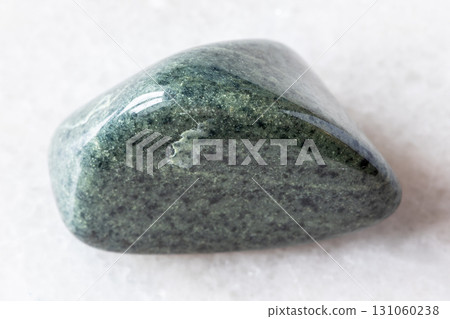 sample of tumbled green quartzite rock on white 131060238