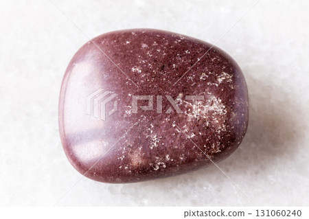 tumbled red brown quartzite rock on white marble tumbled red brown quartzite rock on white marble 131060240