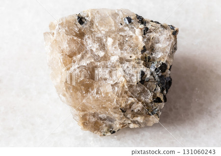 sample of cryolite rock with annite mica on white sample of cryolite rock with annite mica on white 131060243