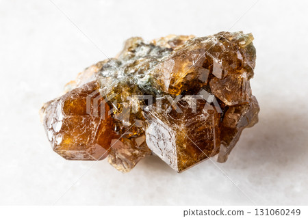sample of raw hessonite grossular mineral on white sample of raw hessonite grossular mineral on white 131060249