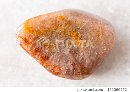 polished iridescent feldspar mineral on white 131060252