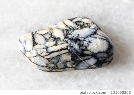 sample of tumbled pinolite mineral on white marble sample of tumbled pinolite mineral on white marble 131060268