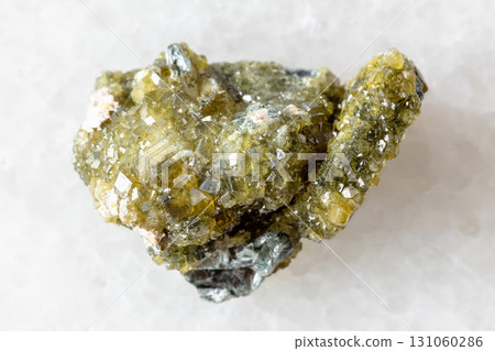 raw druse of topazolite andradite mineral on white raw druse of topazolite andradite mineral on white 131060286