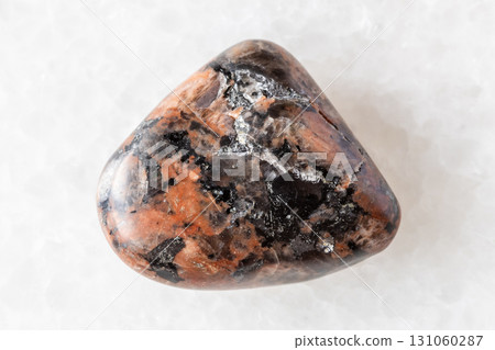 sample of polished granosyenite rock on white 131060287