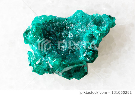 sample of rough dioptase mineral on white marble 131060291