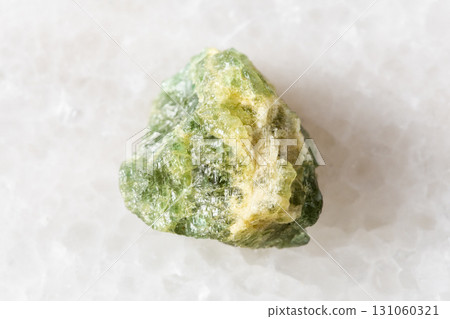 rough yellow green beryl mineral on white marble 131060321