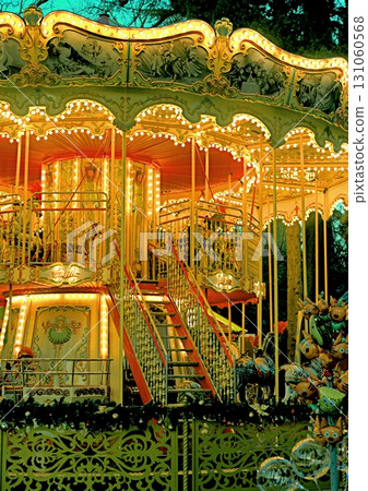 Christmas carousel with horses on the square in the city 131060568