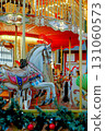 Christmas carousel with horses on the square in the city 131060573