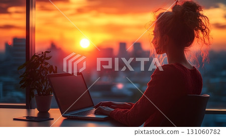 Woman Working on Laptop at Sunset View Woman Working on Laptop at Sunset View 131060782