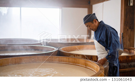 Soy Sauce Maker Checking Fermentation Process in Wooden Tanks Soy Sauce Maker Checking Fermentation Process in Wooden Tanks 131061043