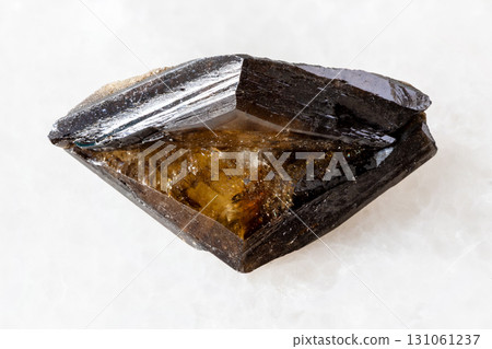 raw twinned brown titanite crystal on white marble raw twinned brown titanite crystal on white marble 131061237