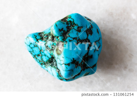 sample of tumbled turquonite mineral on white 131061254