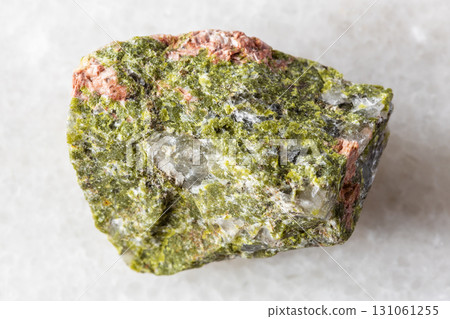 sample of raw unakite mineral on white marble 131061255