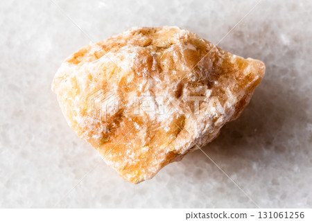 sample of uncut brown calcite mineral on white 131061256