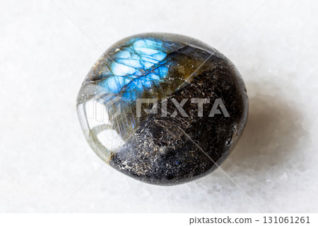sample of polished labradorite gemstone on white 131061261