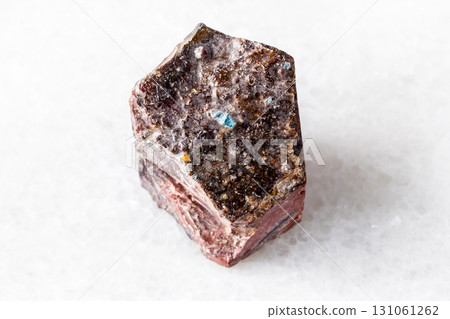 sample of rough mookaite rock on white marble 131061262