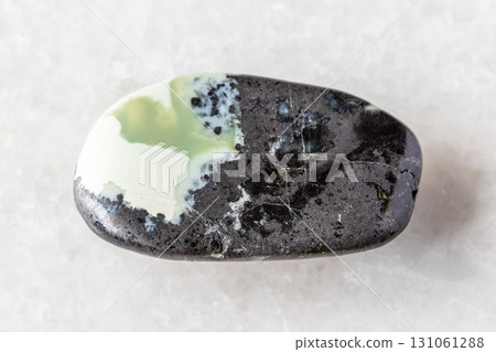 sample of polished khantigirite mineral on white 131061288