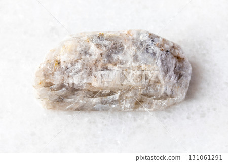 raw belomorite moonstone rock on white marble 131061291
