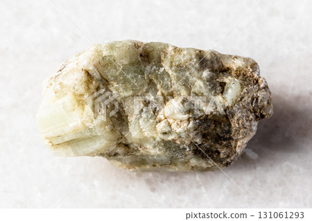 sample of raw beryl rock on white marble 131061293