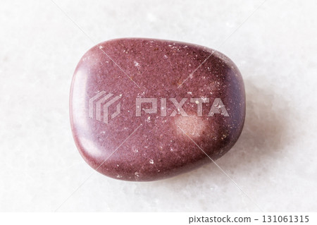 polished red brown quartzite rock on white marble 131061315