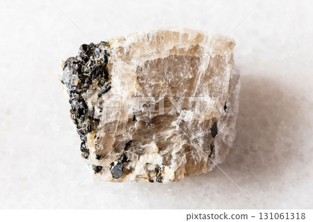 raw cryolite mineral with annite mica on white 131061318