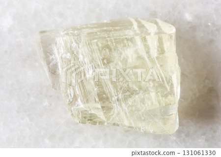 sample of raw spodumene mineral on white marble 131061330