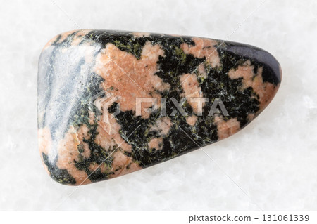 sample of polished gabbro rock on white marble 131061339