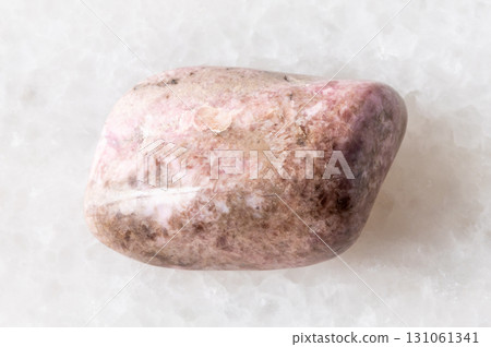 sample of tumbled pyroxmangite mineral on white 131061341