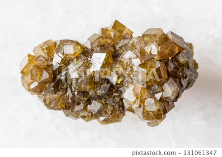 rough druse of andradite garnet crystals on white rough druse of andradite garnet crystals on white 131061347
