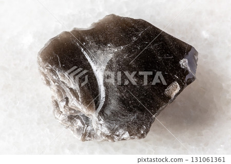 sample of rough obsidian rock on white marble sample of rough obsidian rock on white marble 131061361