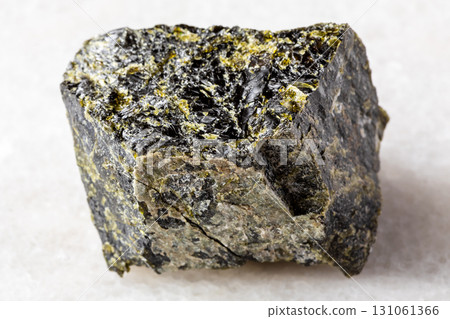 sample of raw diopside mineral on white marble sample of raw diopside mineral on white marble 131061366