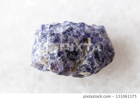 sample of raw cordierite mineral on white marble sample of raw cordierite mineral on white marble 131061375