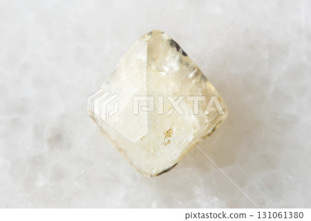 sample of raw topaz crystal on white marble 131061380