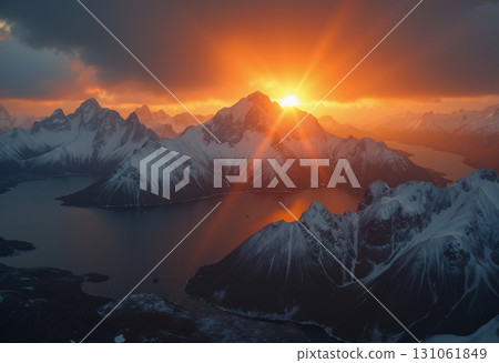 A beautiful northern landscape at sunset, with snow-covered mountains and a lake. 131061849