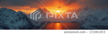 A beautiful northern landscape at sunset, with snow-covered mountains and a lake. 131061853