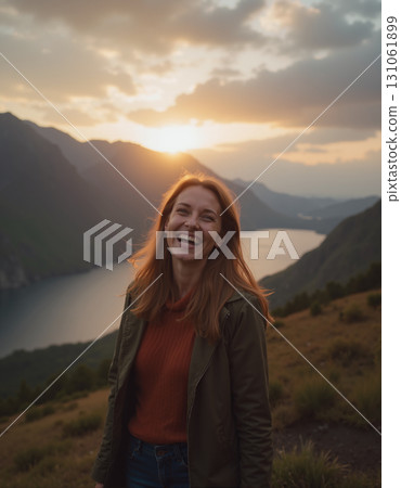 A portrait of a woman stands against a beautiful landscape featuring a fjord, lake, and sunset sky. 131061899