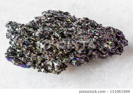 sample of raw carborundum rock on white marble 131061999