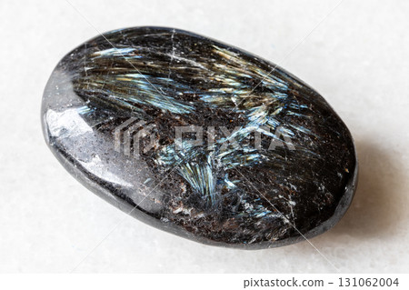 sample of polished nuummite rock on white marble sample of polished nuummite rock on white marble 131062004