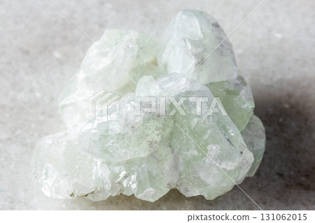 sample of rough datolite mineral on white marble 131062015