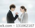 A man and woman sharing business success and shaking hands firmly 131062107