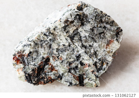 sample of raw foyaite rock on white marble sample of raw foyaite rock on white marble 131062127