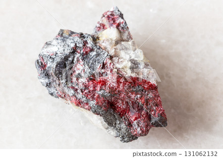 raw cinnabar, stibnite on fluorite rock on white raw cinnabar, stibnite on fluorite rock on white 131062132