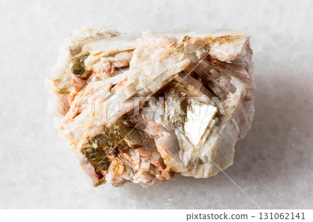 sample of raw albite rock with muscovite on white sample of raw albite rock with muscovite on white 131062141