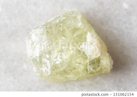 sample of raw hiddenite mineral on white marble sample of raw hiddenite mineral on white marble 131062154