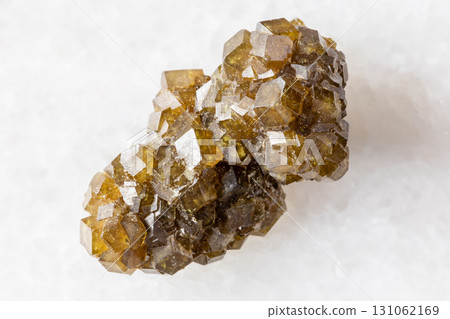 raw druse of andradite garnet crystals on white raw druse of andradite garnet crystals on white 131062169