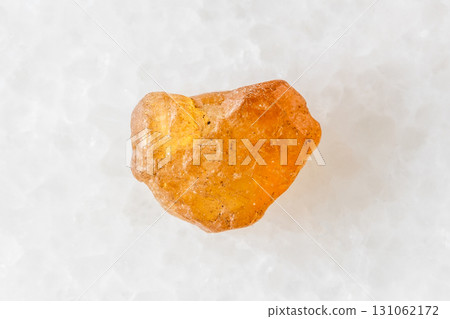 unpolished hessonite grossular crystal on white unpolished hessonite grossular crystal on white 131062172