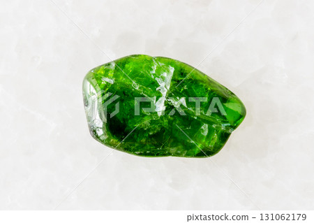 tumbled chromian diopside stone on white marble tumbled chromian diopside stone on white marble 131062179